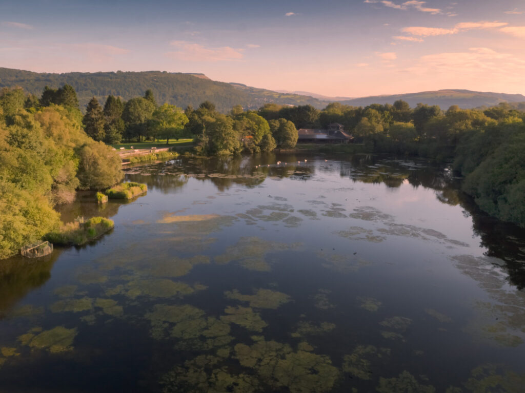 Aerial view of lake infront of the visitor centre in Gnoll Estate Country Park